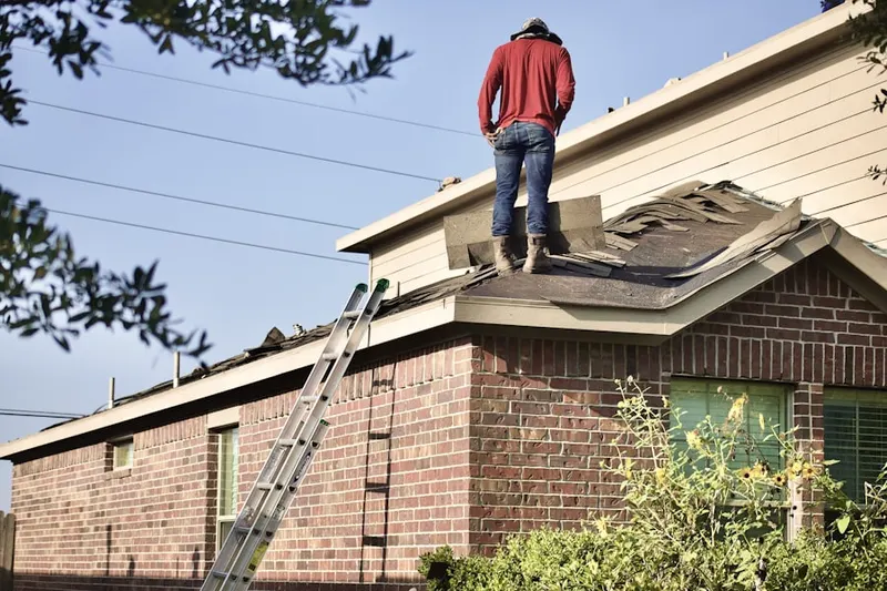 Professional roofer working on a residential roof in Springlake-University Terrace